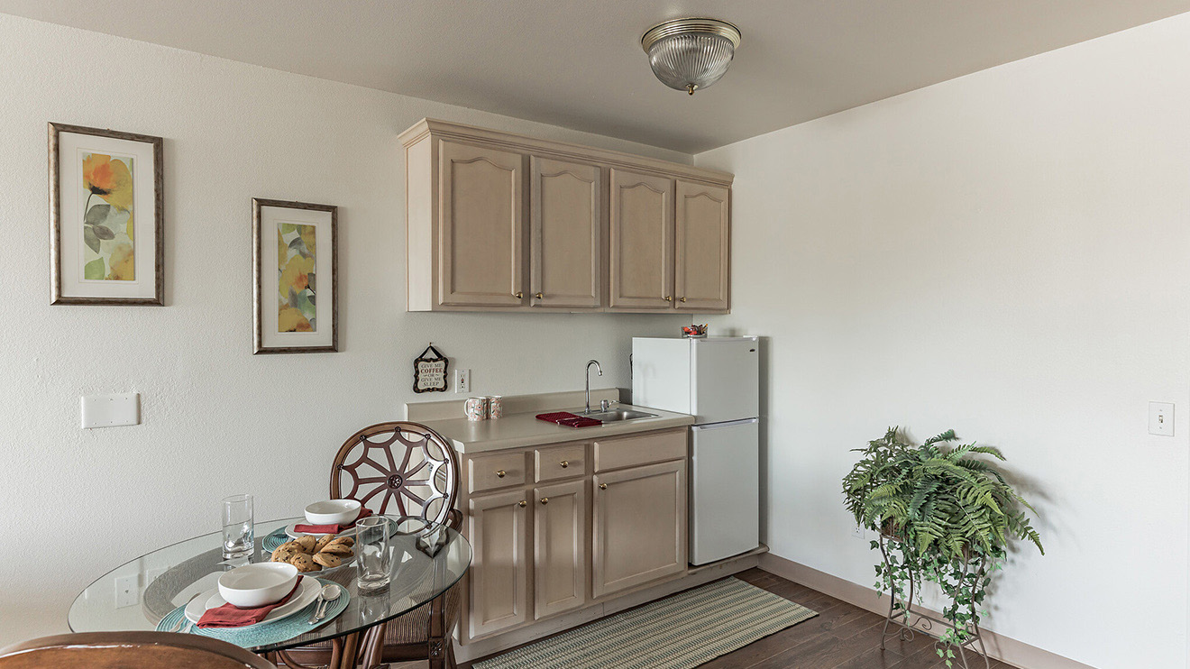 Retirement housing with dining space, kitchenette and refrigerator at Holiday Vista del Rio.